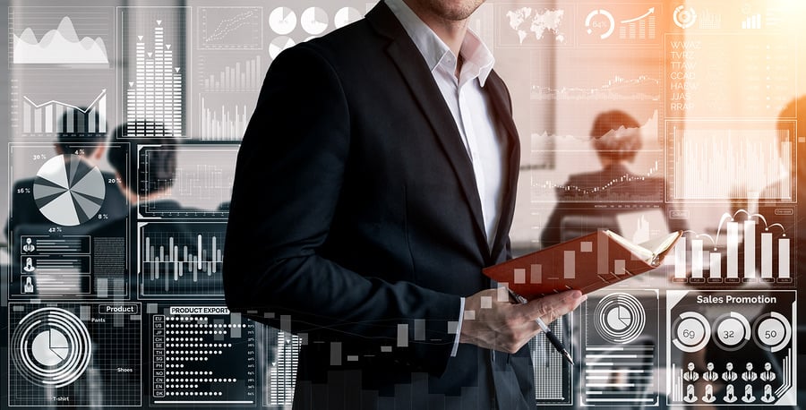 Businessman with a tablet surrounded by data and chart graphics