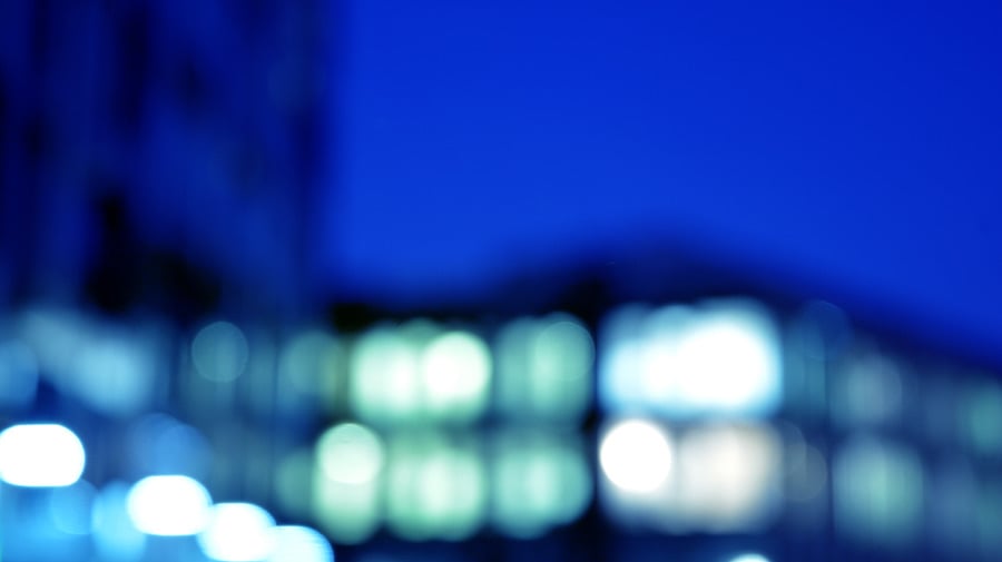 Blurred night view of an illuminated office building exterior