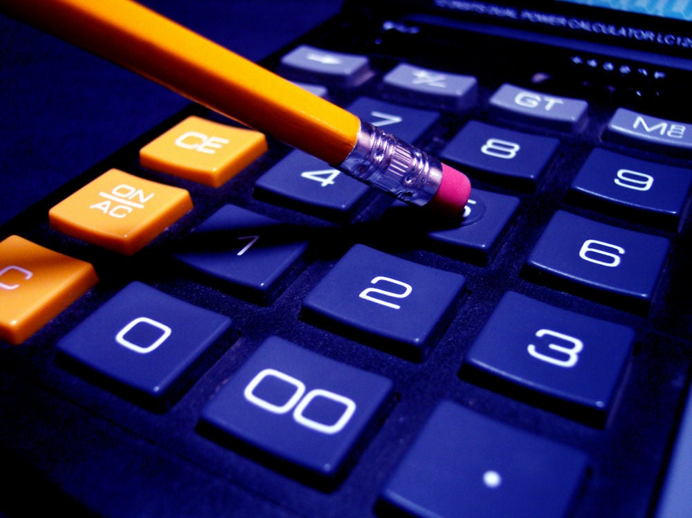 Pencil eraser resting on a calculator's number pad
