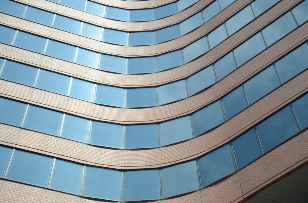 Curved glass facade of a modern high-rise building