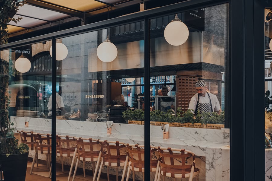Restaurant storefront with an outdoor bar and seating area