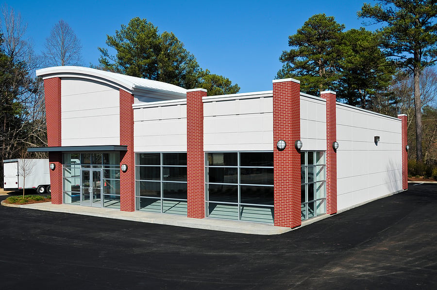 Exterior of a new brick and glass commercial storefront building