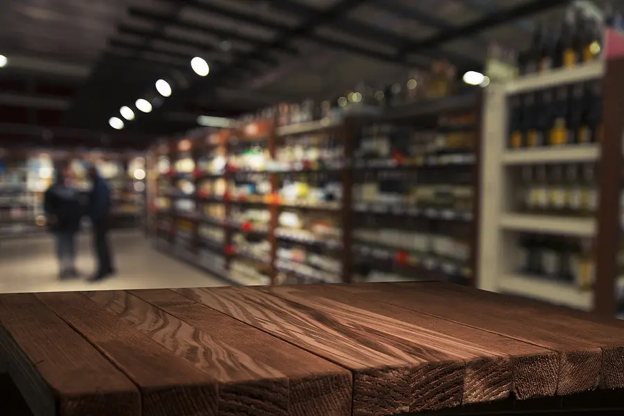 Wooden counter in front of blurred store shelving